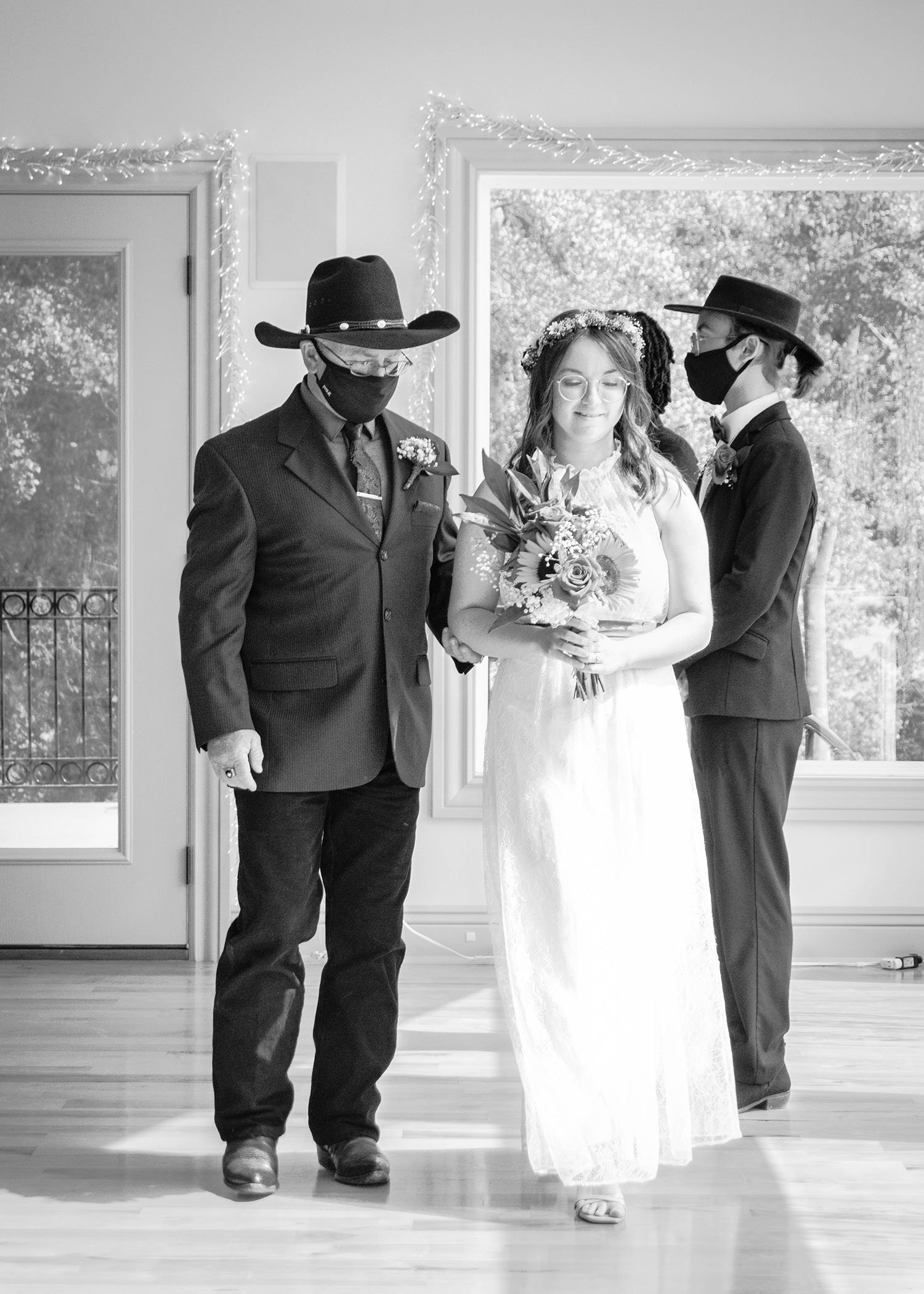 The father of the bride escorts his daughter to the altar.