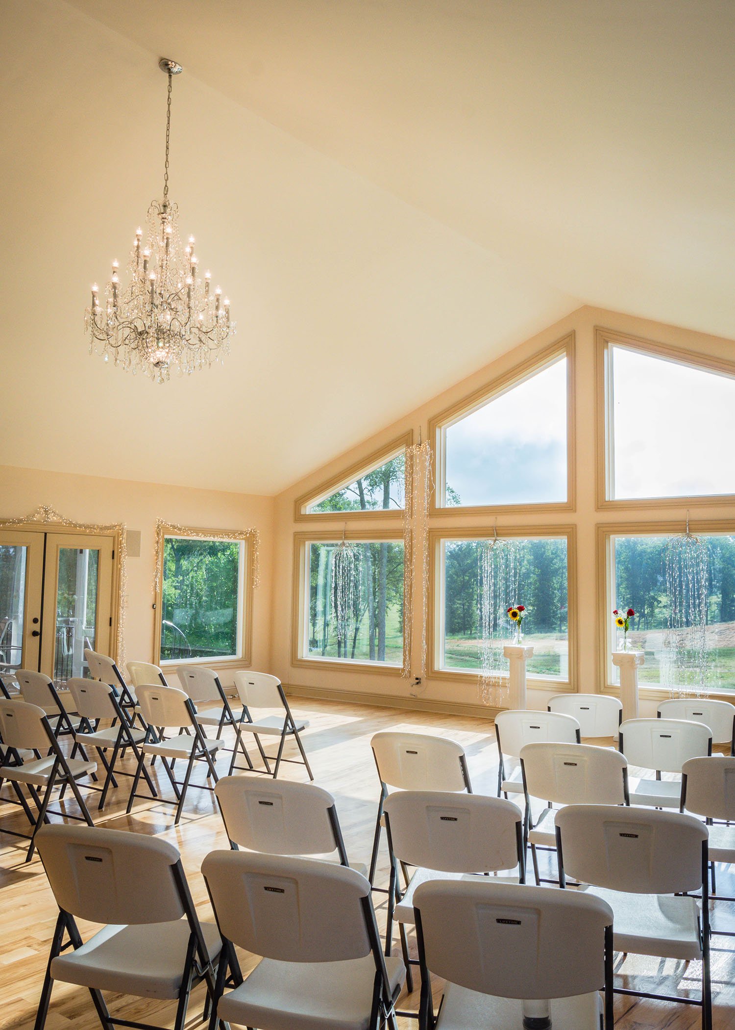 Davidson Farm, a wedding venue in South Carolina, features large prominent windows and a humble chandelier.