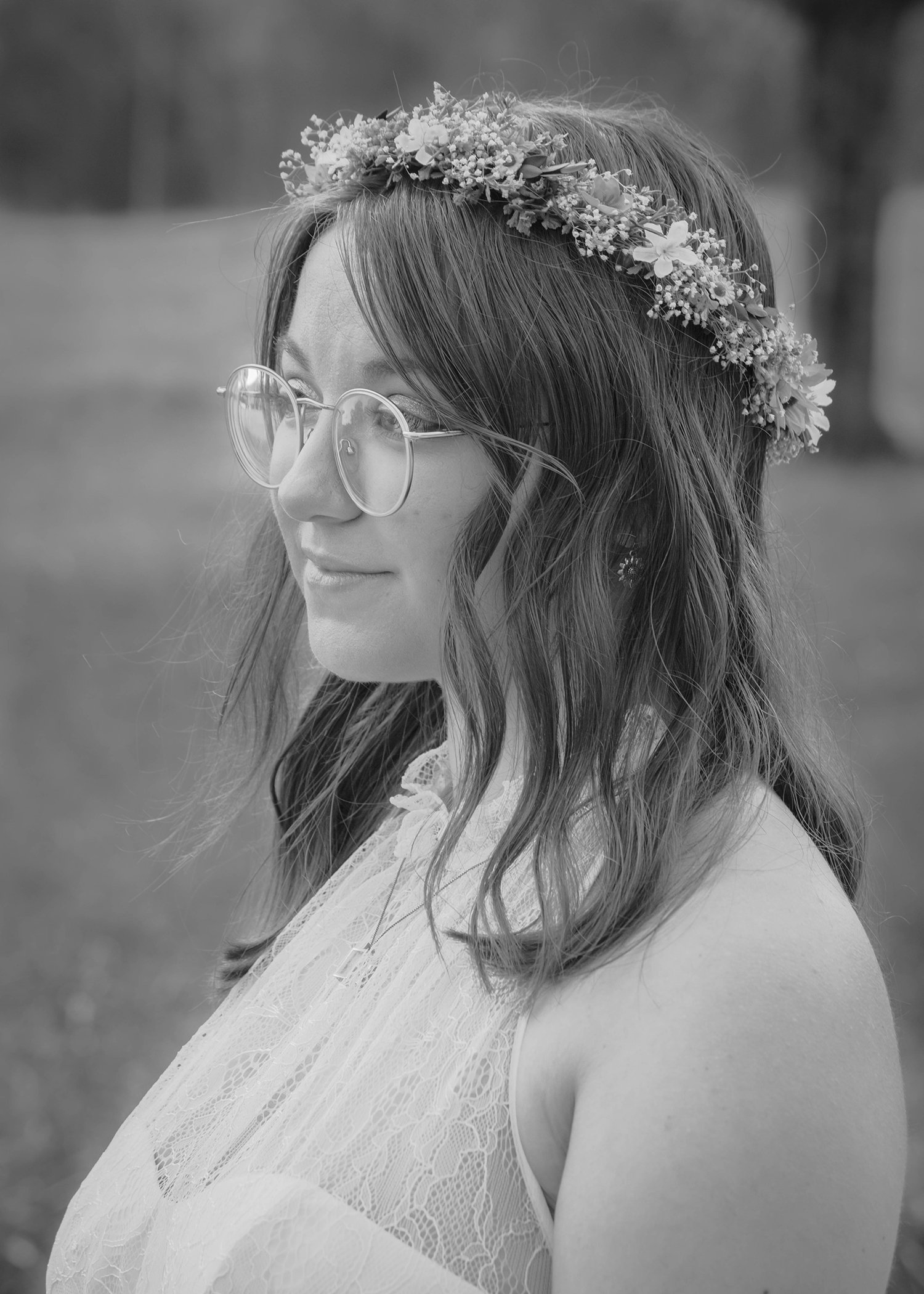 An LGBTQ bride stands outside the wedding venue at Davidson Farm for bridal portraits.