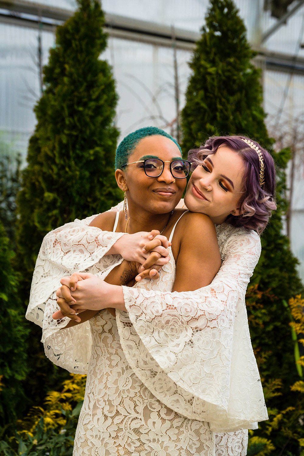 A non-binary lesbian couple embrace one another on their elopement day.