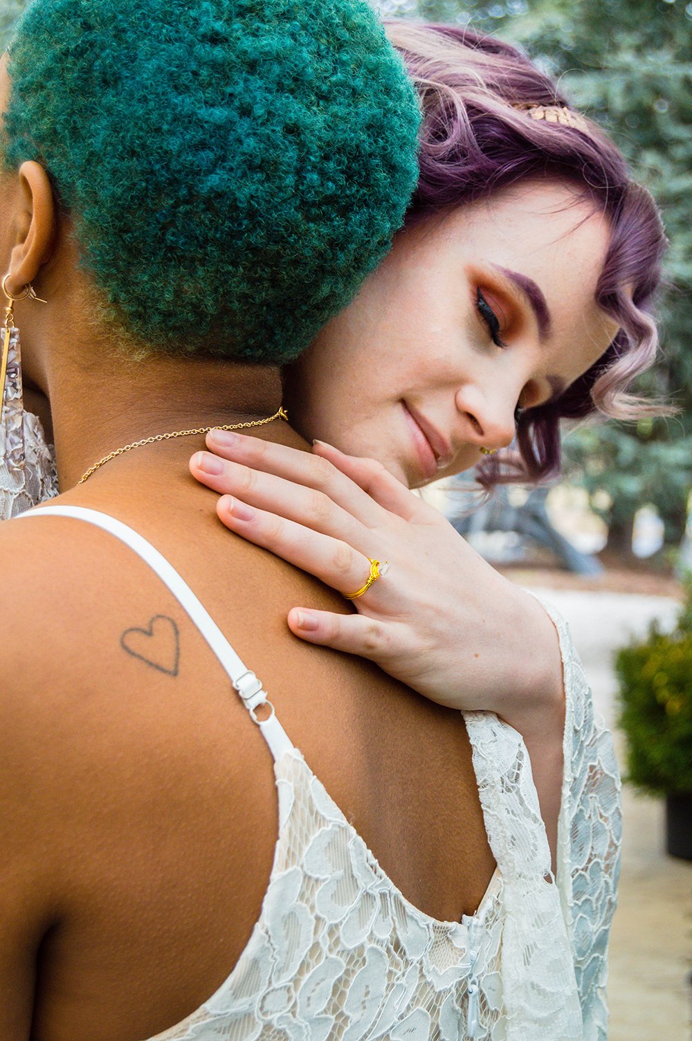 An LGBTQ+ couple embraces on their elopement day.