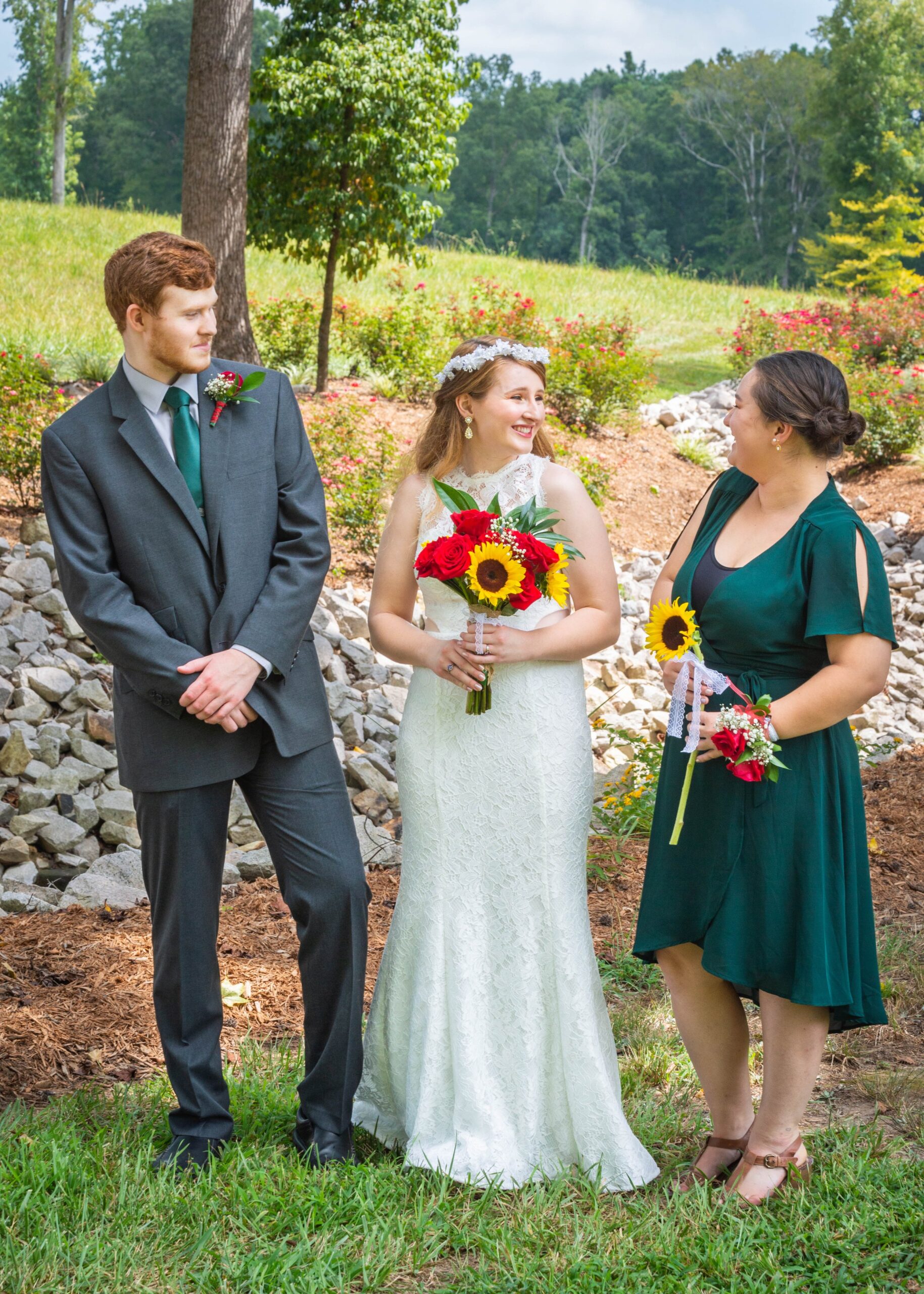 An LGBTQ+ marrier stands between two members of their wedding party during their gender neutral wedding.