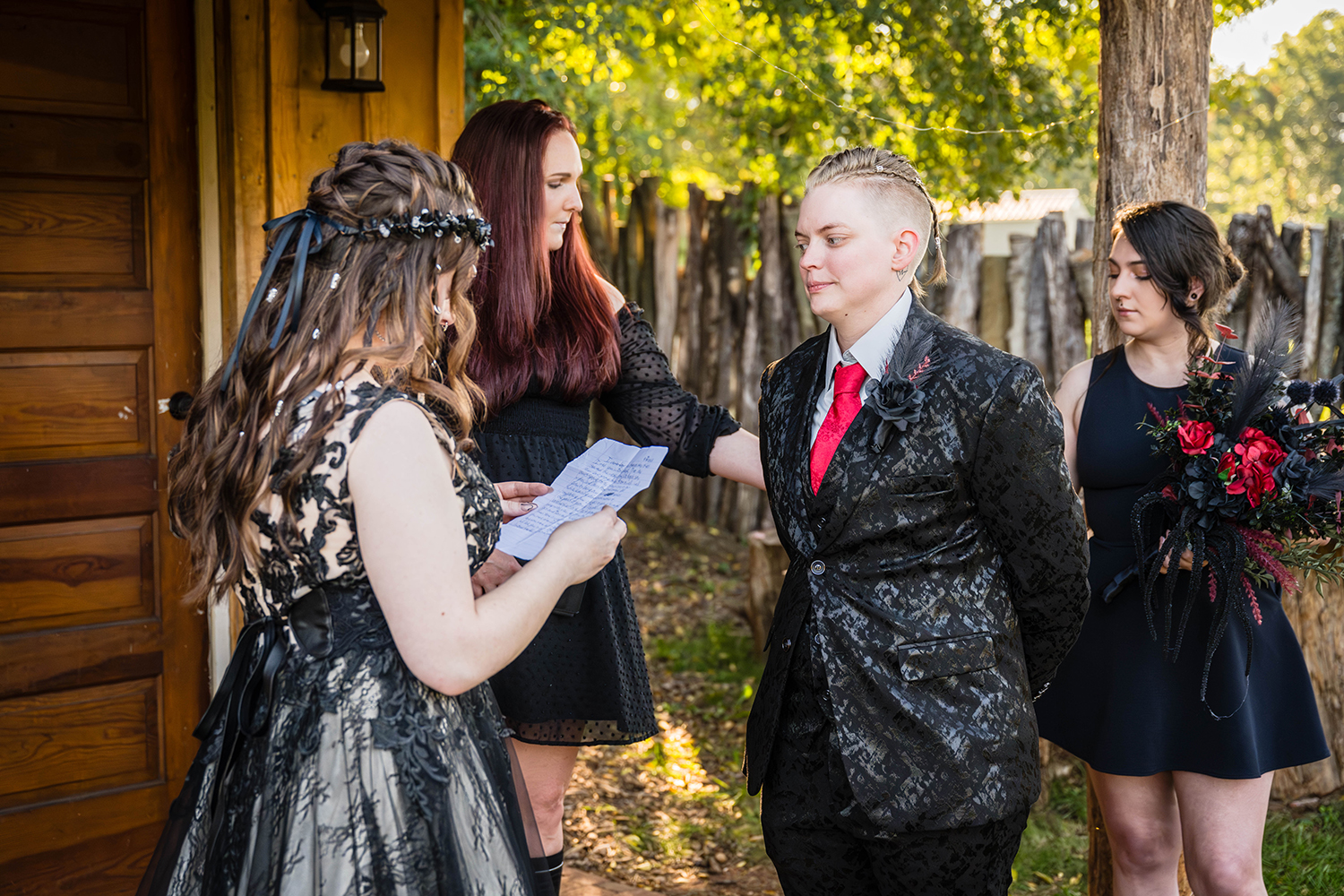 An officiant asks for the rings from a wedding party member while the couple reads their vows during their elopement ceremony.