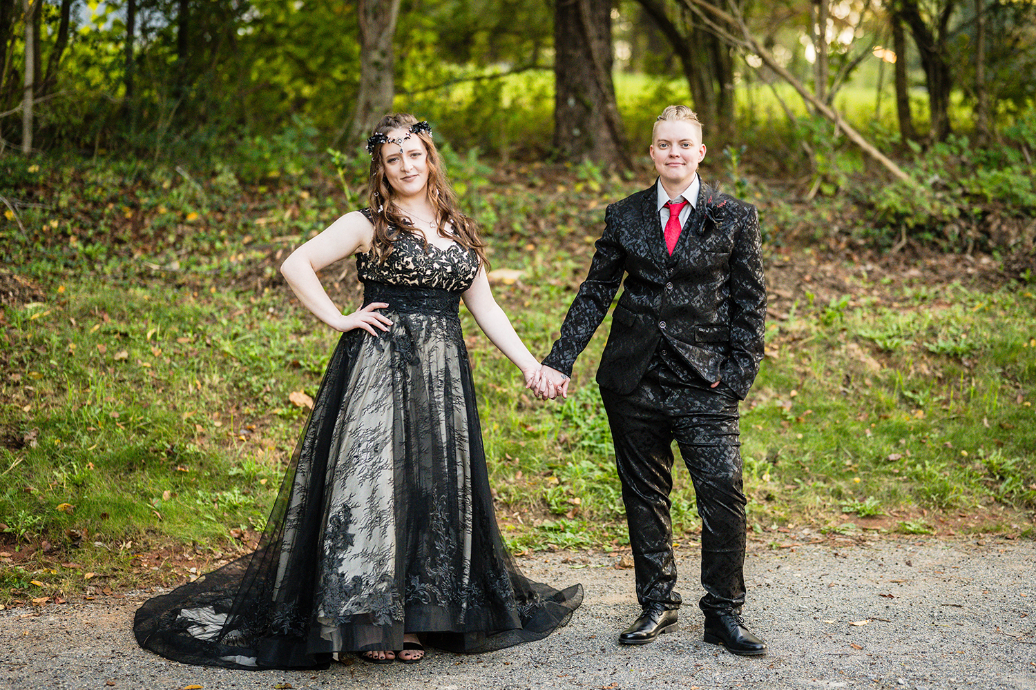 A lesbian couple holds hands and poses outside of their Roanoke Airbnb for a photo on their elopement day.