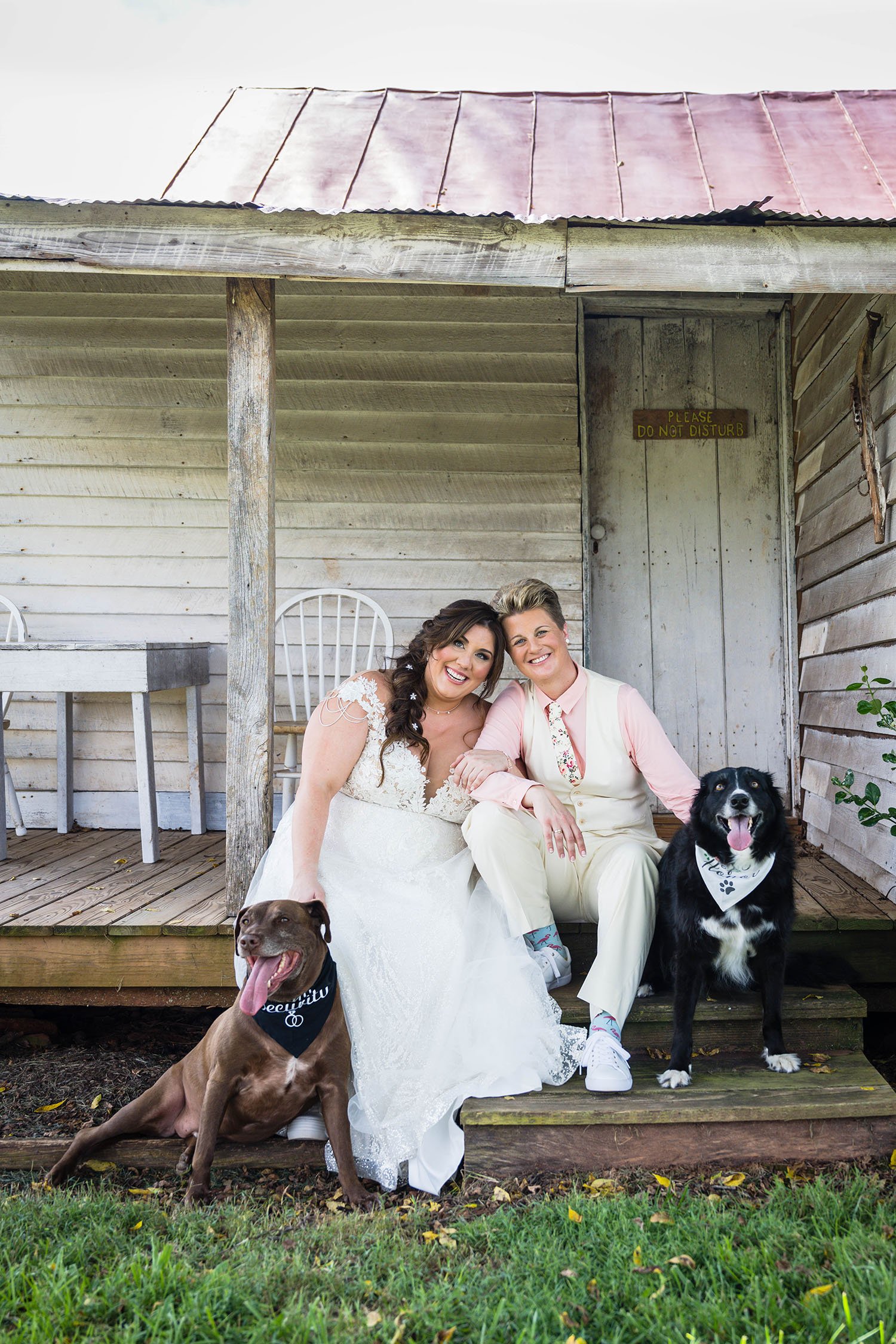 LGBTQ couple poses with their dogs at Pavilion at Black Water Junction in Union Hall, Virginia.