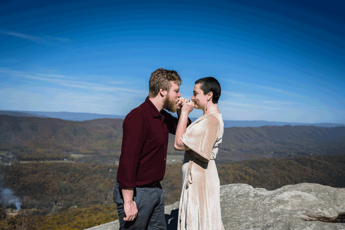 A GIF of a couple making a pinky promise and then kissing one another at the summit of McAfee's Knob during their adventure elopement.