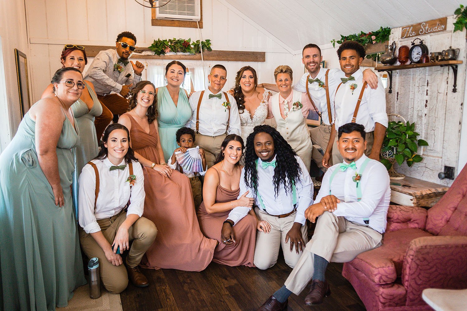 Both wedding parties squeeze together in the bridal suite for a group photo prior to the wedding ceremony at the Pavilion at Black Water Junction.