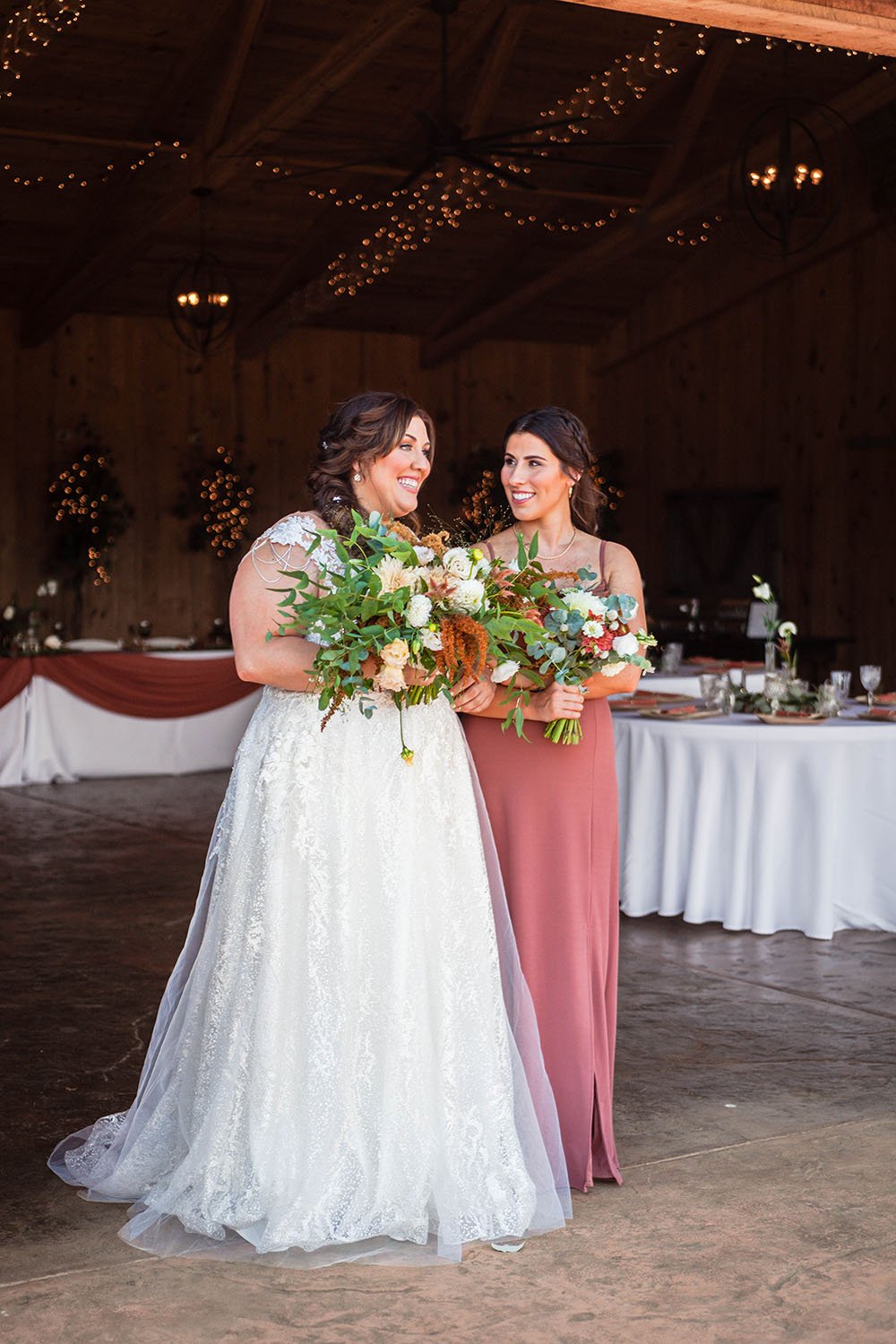 An lgtbq+ bride links arms with their sister as they begin to walk down the aisle.