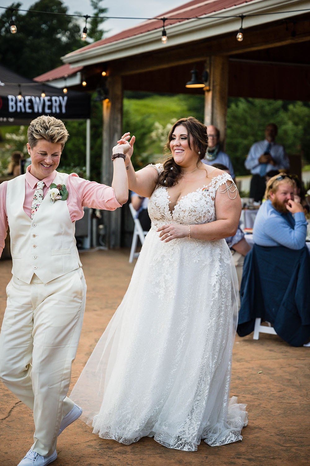 An lgbtq+ newlywed couple take to the dance floor for their first dance at the Pavilion at Black Water Junction.