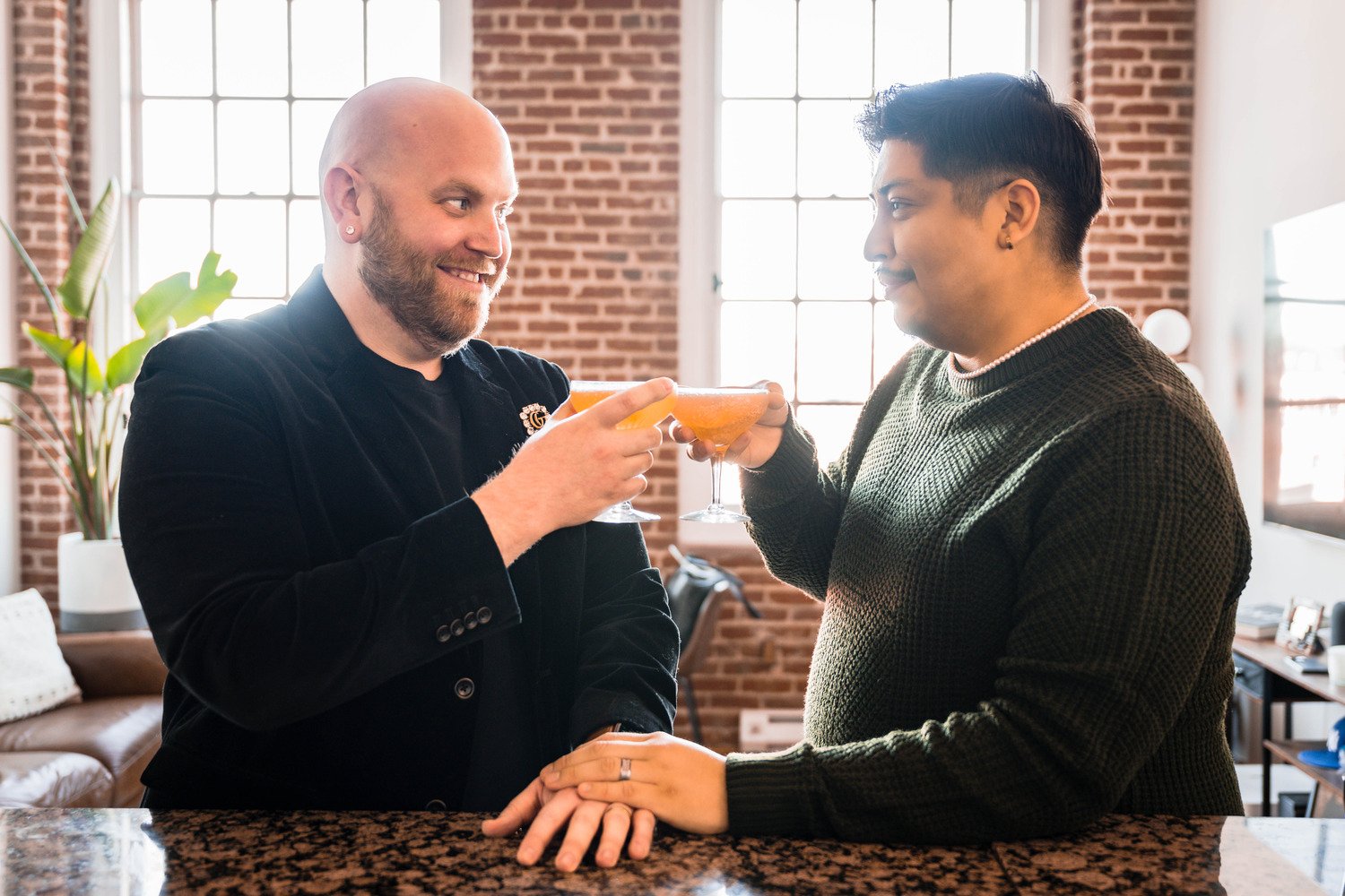 A gay couple makes cocktails in their condo during their at-home photoshoot in Downtown Roanoke.