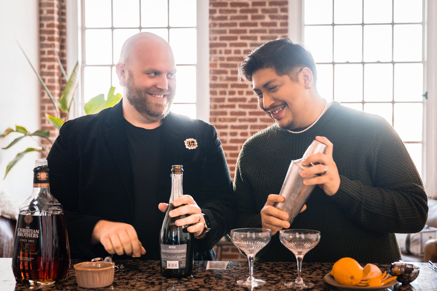 A gay couple makes cocktails in their condo.