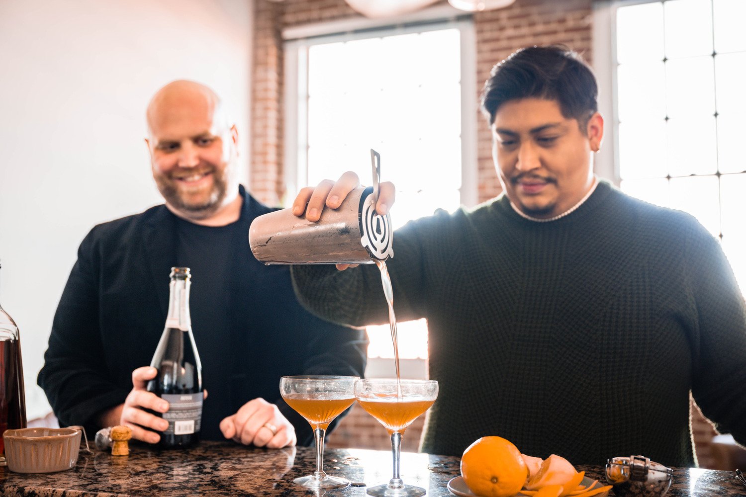 A gay couple makes cocktails in their condo during their at-home photoshoot in Downtown Roanoke.