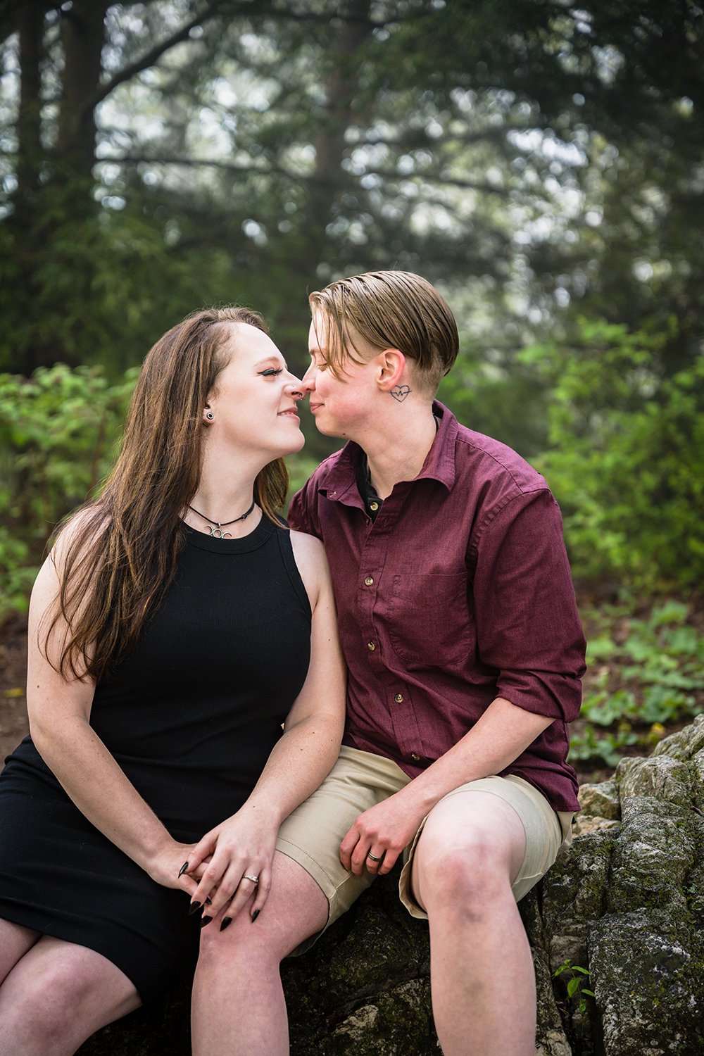 An lgbtq+ couple go in for a kiss during their Roanoke Star engagement session.