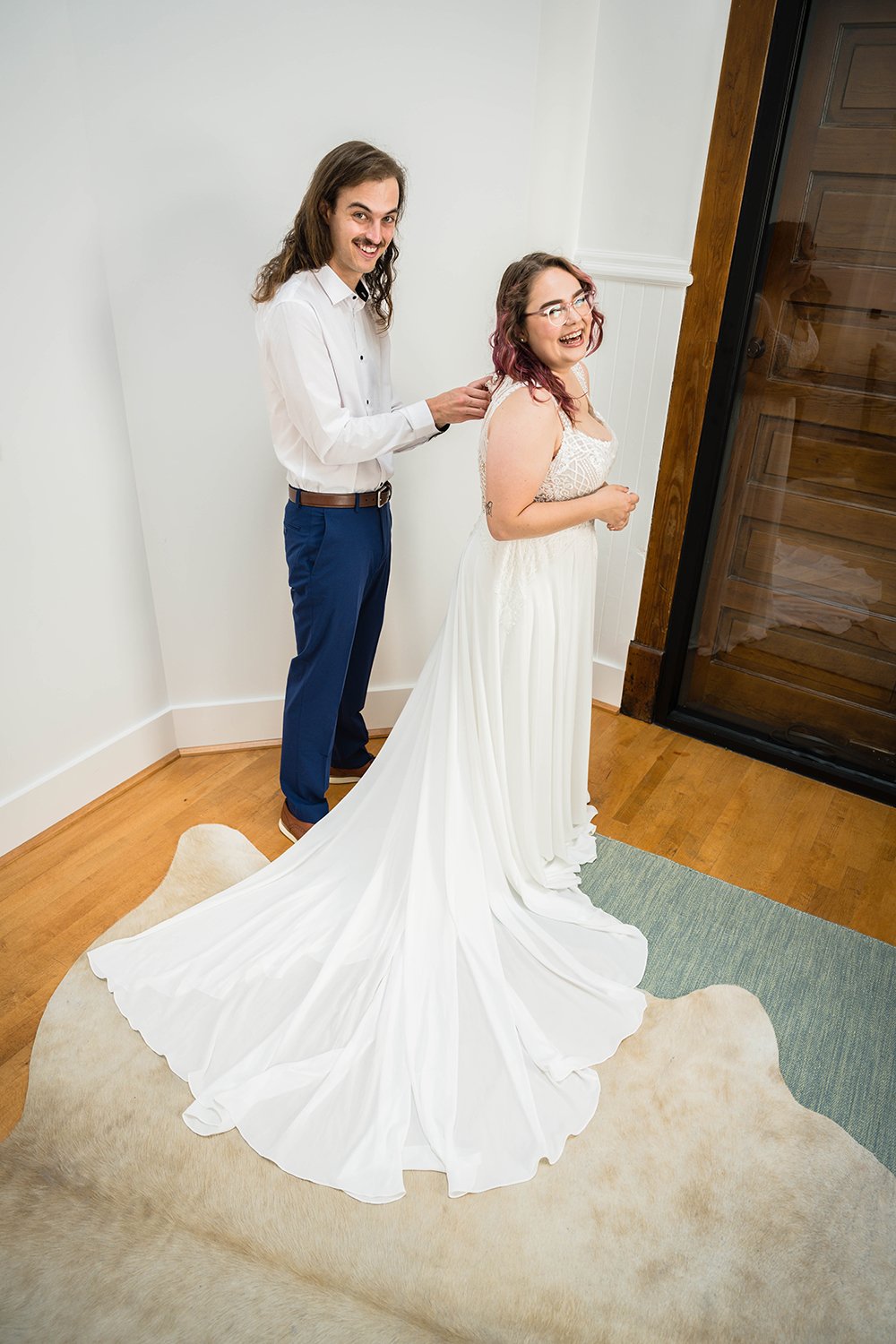A wedding couple getting ready together in the Cottage Room in Fire Station One in Roanoke, Virginia prior to their elopement ceremony.