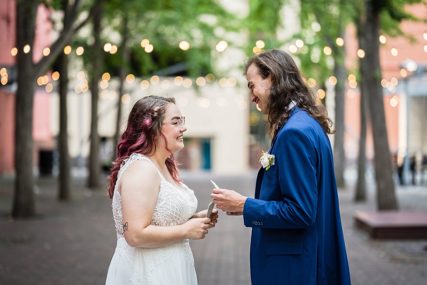 A bride and groom read their vows during their elopement ceremony across the street from Fire Station One.