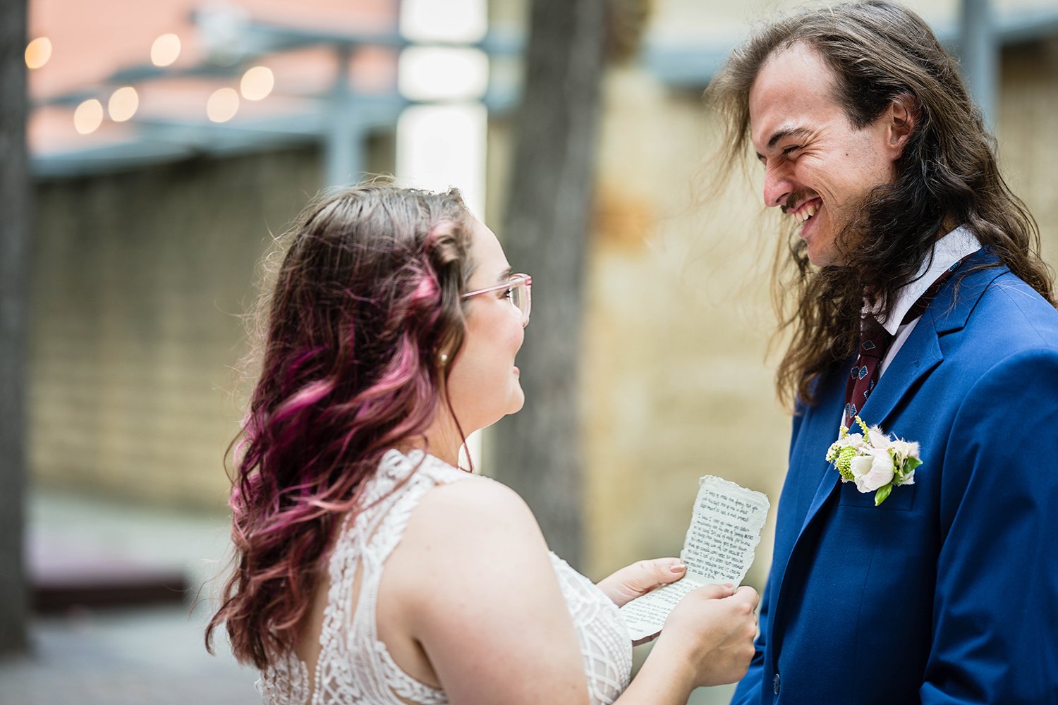 A bride reading her vows to the groom during their elopement ceremony across the street from Fire Station One.