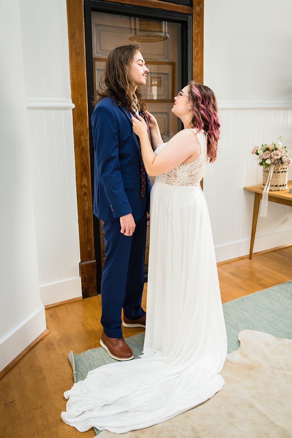A bride and groom get ready together in the Cottage Room in Fire Station One in Roanoke, Virginia prior to their elopement ceremony.