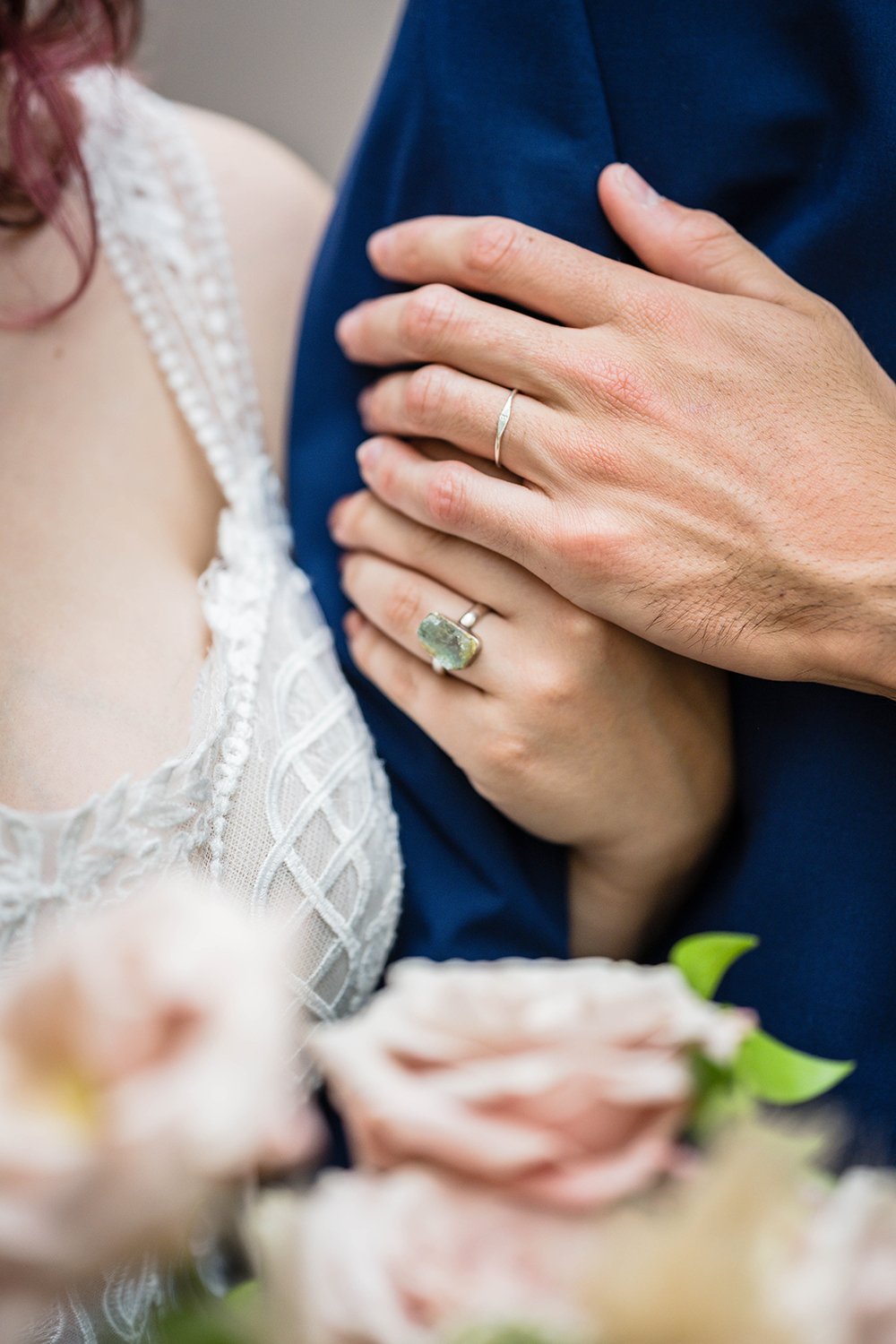 A close up shot of the bride and groom's hands with their wedding rings after their elopement ceremony across the street from Fire Station One.