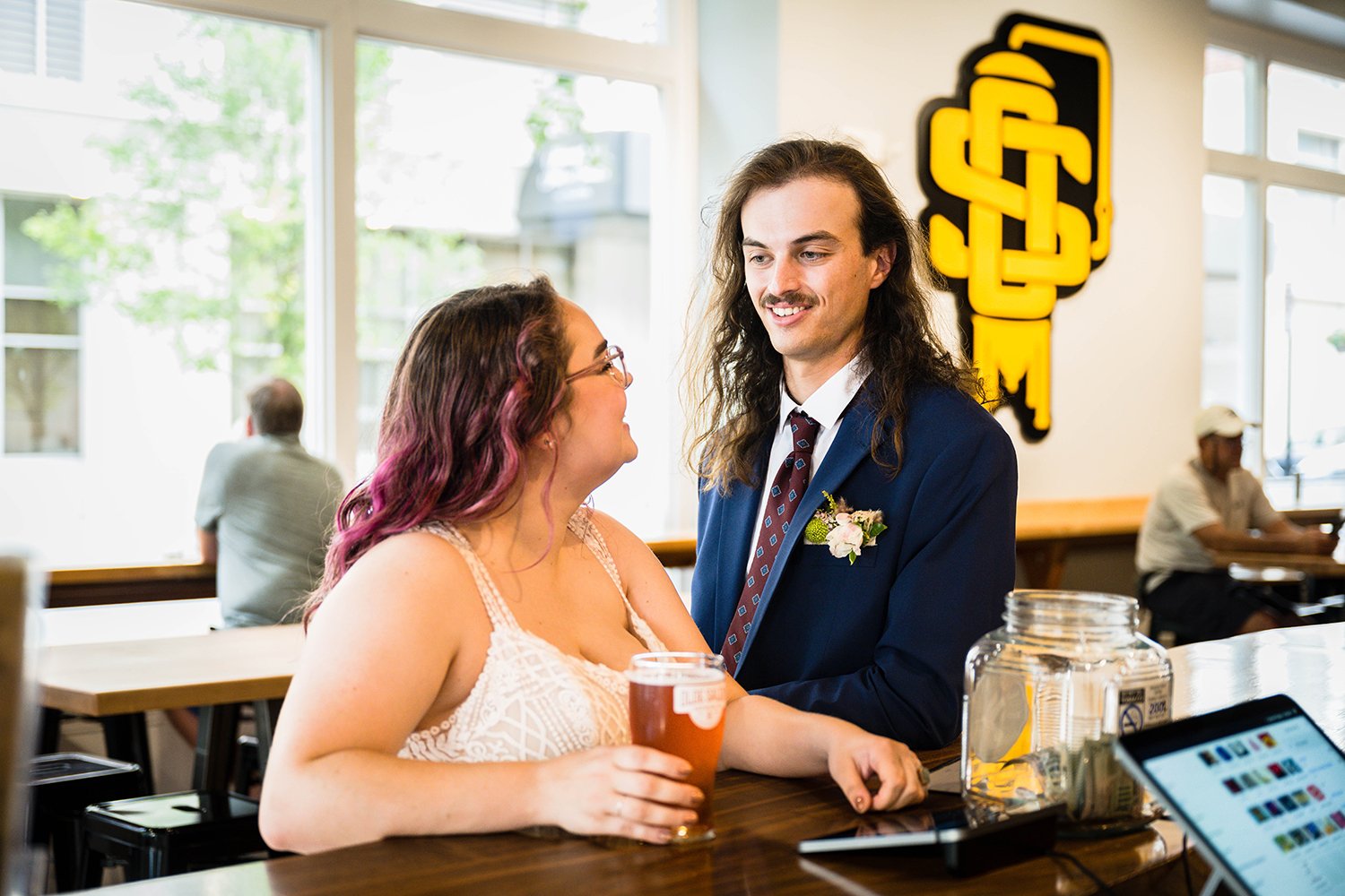 A newlywed couple order beers at Olde Salem Brewing Company.