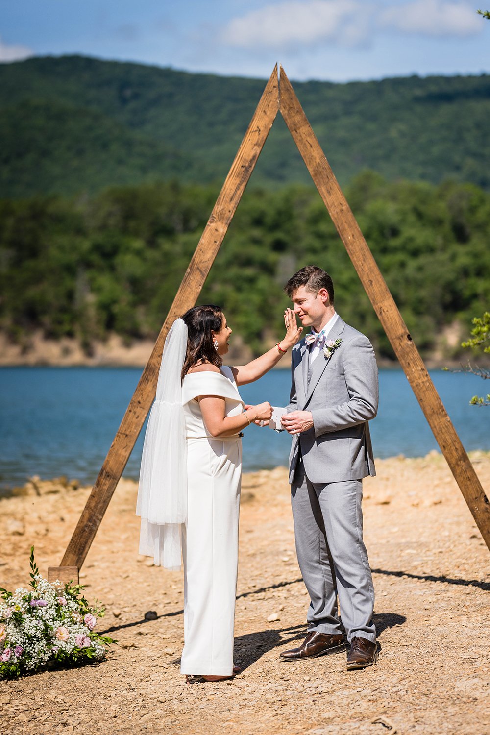 As one marrier finishes reading their vows, their partner wipes away a tear during their elopement at Carvin’s Cove in Roanoke, Virginia.