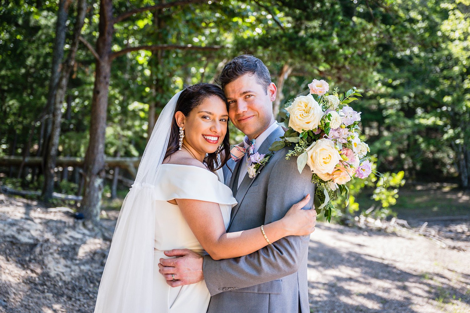 Two newlywed marriers embrace and rest their temples on one another for a photo during their elopement at Carvin's Cove in Roanoke, Virginia.