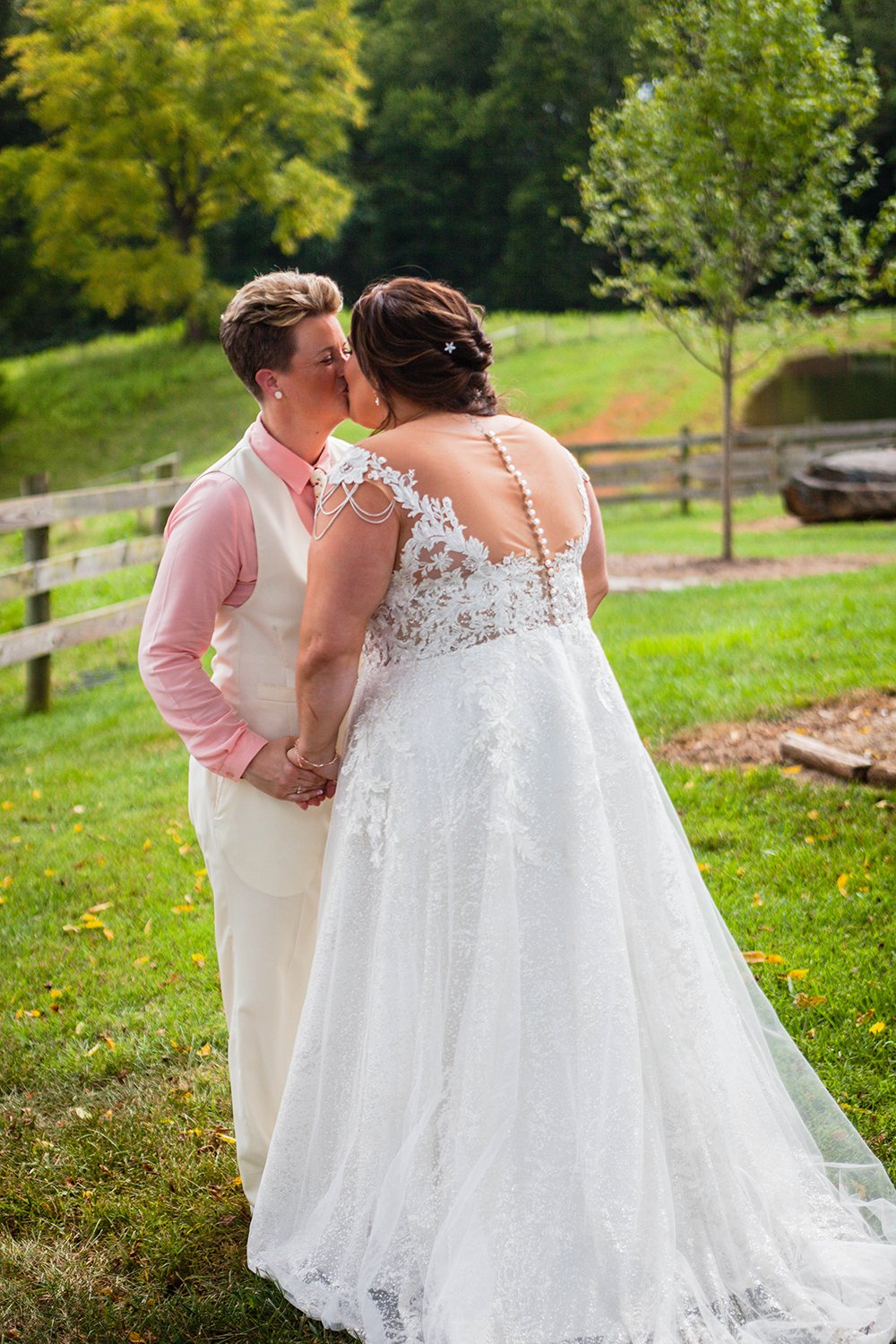 A lesbian couple kisses one another after their first look on their wedding day in Virginia.