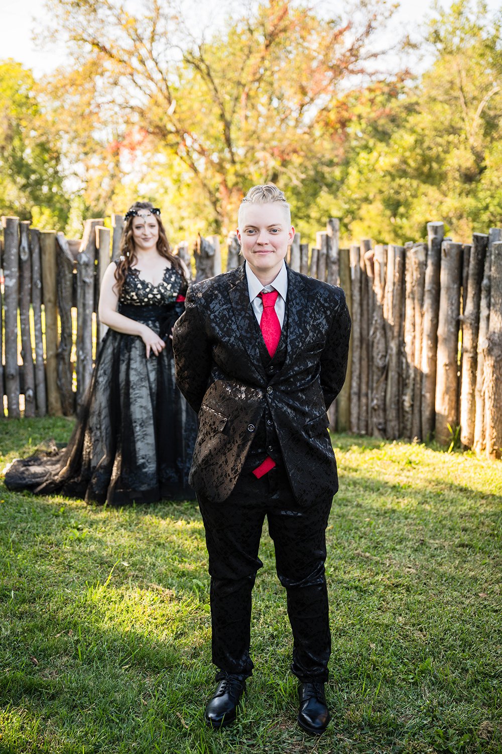 Two LGBTQ+ marriers stand in the yard of a Roanoke Airbnb on their elopement day for their first look.