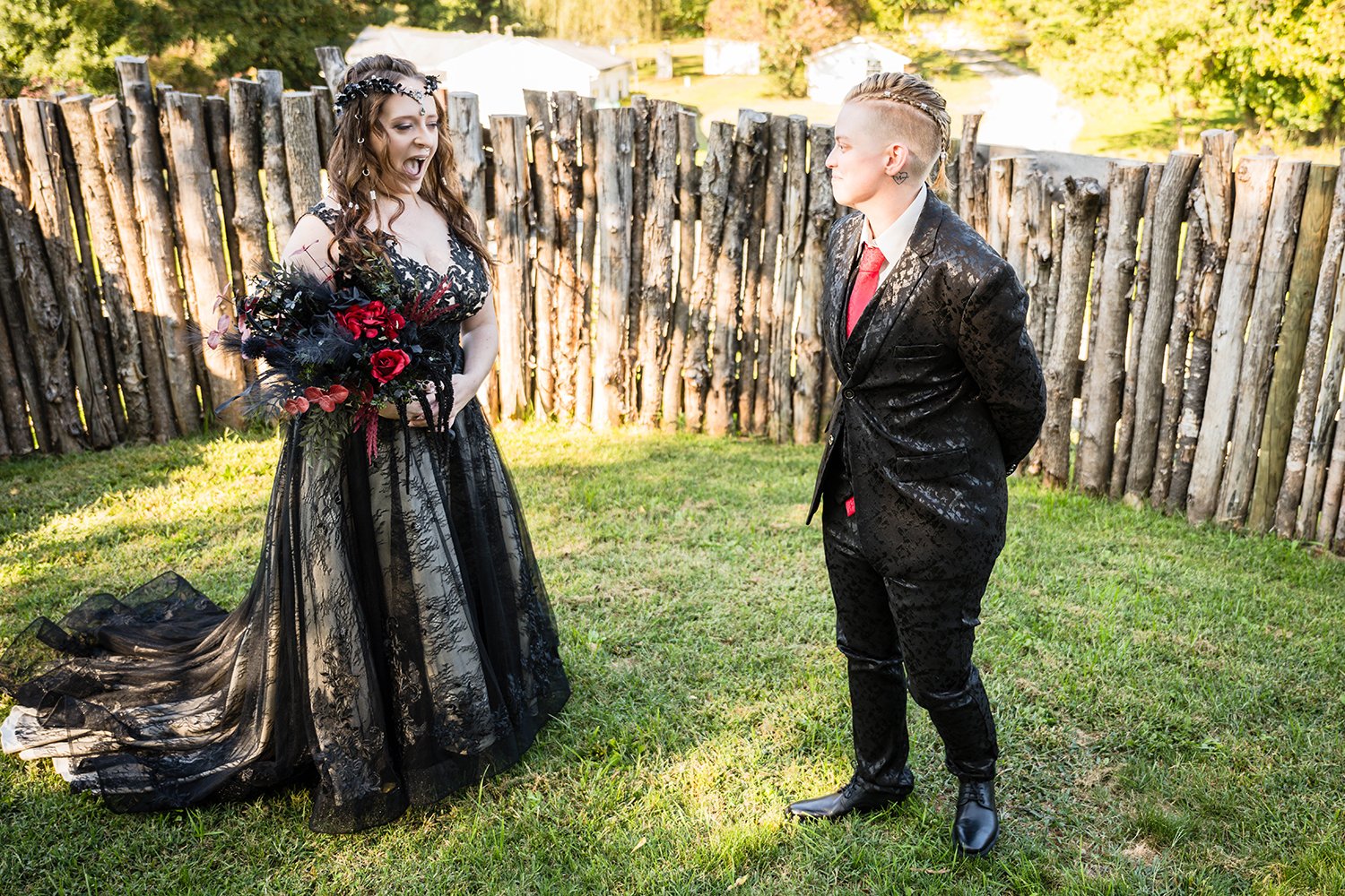 A queer wedding couple look at one another with surprise during their first look reveal in the yard of a Roanoke Airbnb on their elopement day.