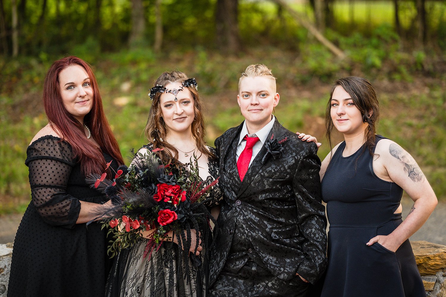 An LGBTQ+ wedding couple stands with their wedding party for a photo outside of their Roanoke Airbnb on their elopement day.