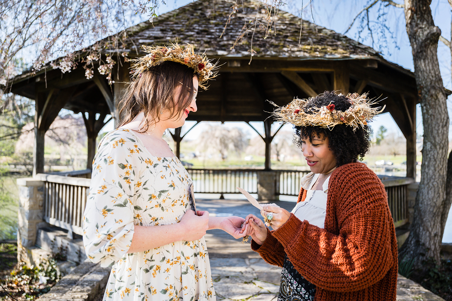 A queer couple exchange vows at Duck Pond near the gazebo on Virginia Tech's campus.