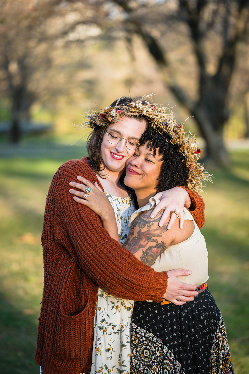 An LGBTQ+ couple embrace, smile widely, and close their eyes as the sun sets on their elopement day at Duck Pond in Blacksburg, Virginia.
