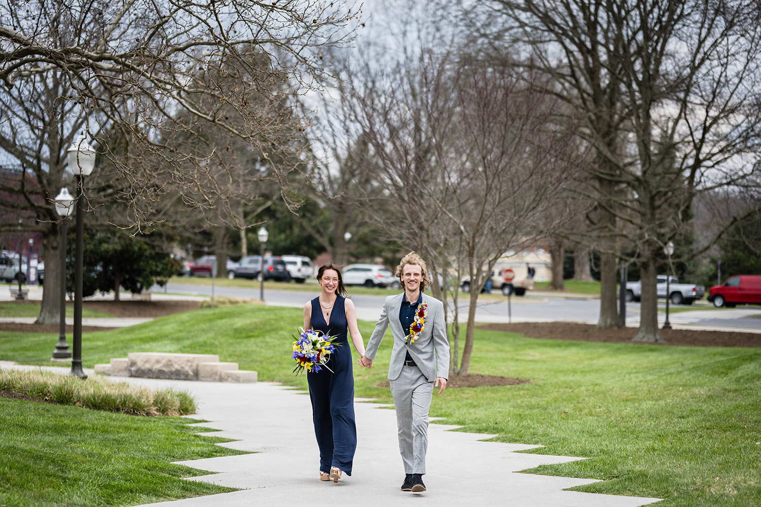 A newlywed couple walk hand-in-hand on Virginia Tech's campus.
