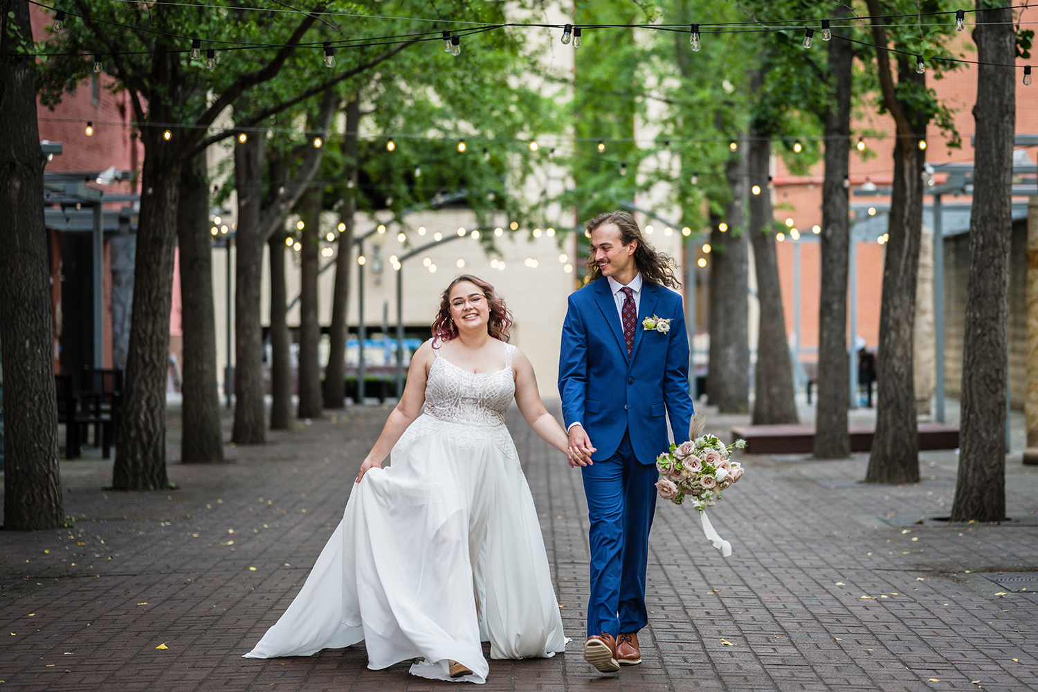 A couple walk hand-in-hand following their ceremony in Downtown Roanoke with smiles on their faces during their wedding guest free elopement day.
