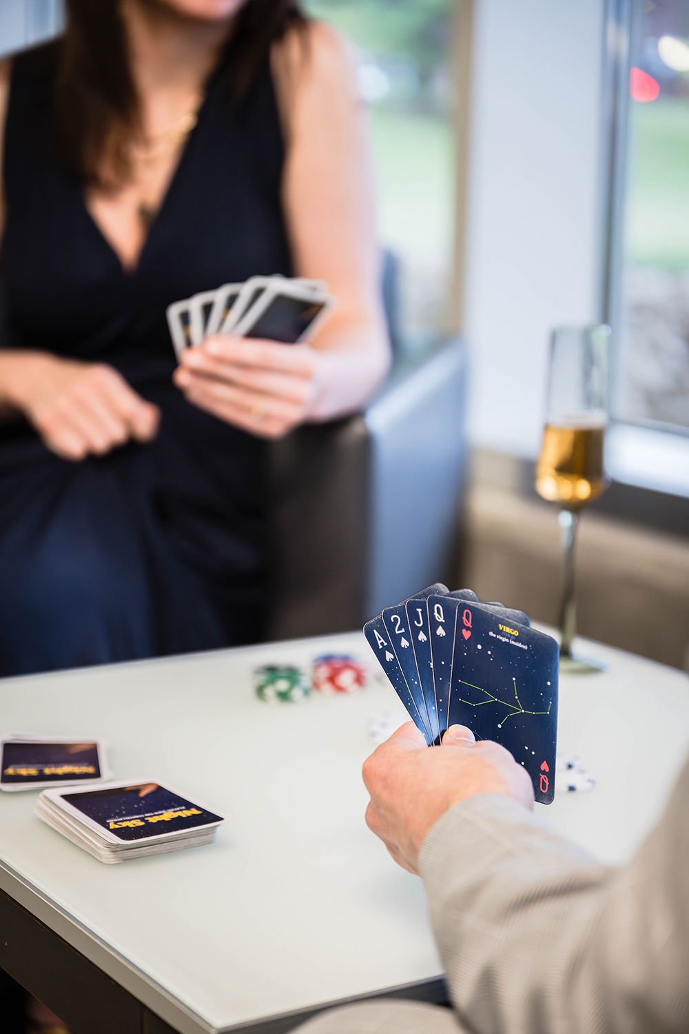 A marrier holds a hand of five cards during a game of five card stud against their partner.
