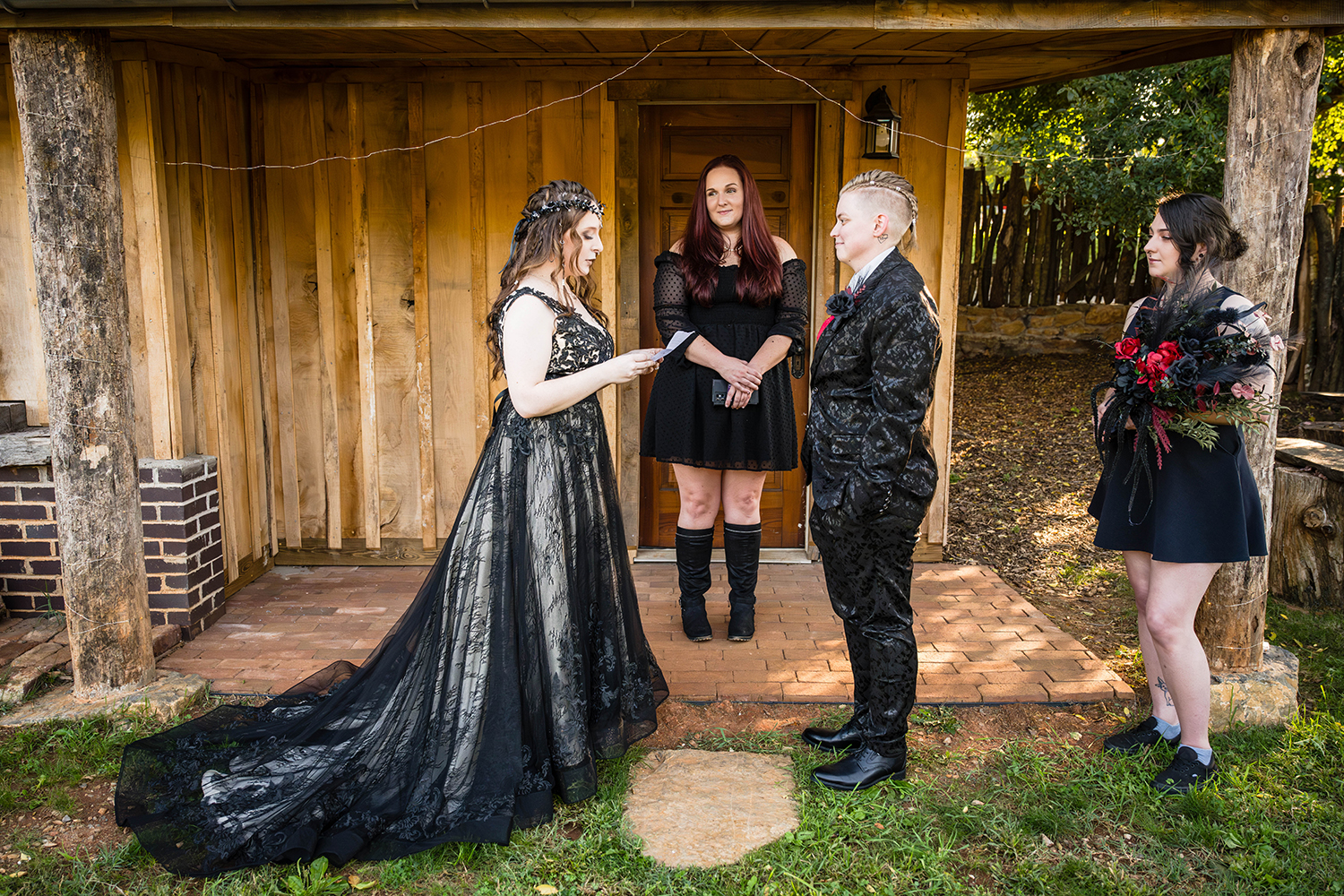 An LGBTQ+ couple read their vows to one another in a backyard ceremony on their elopement day, joined by two close friends. 