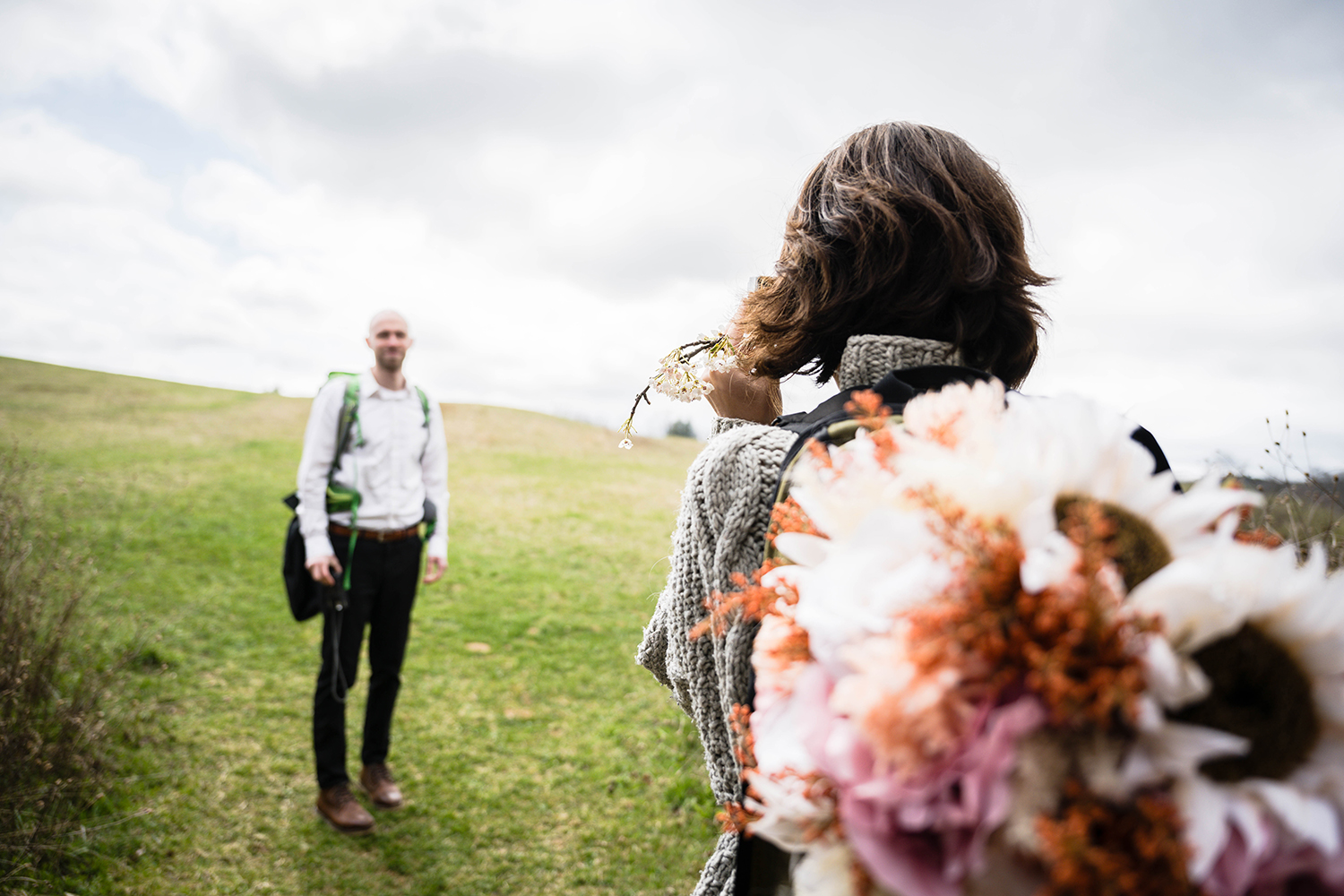 A bride takes a photo of her groom with her film camera during their elopement day hike on the Appalachian Trail in Virginia.