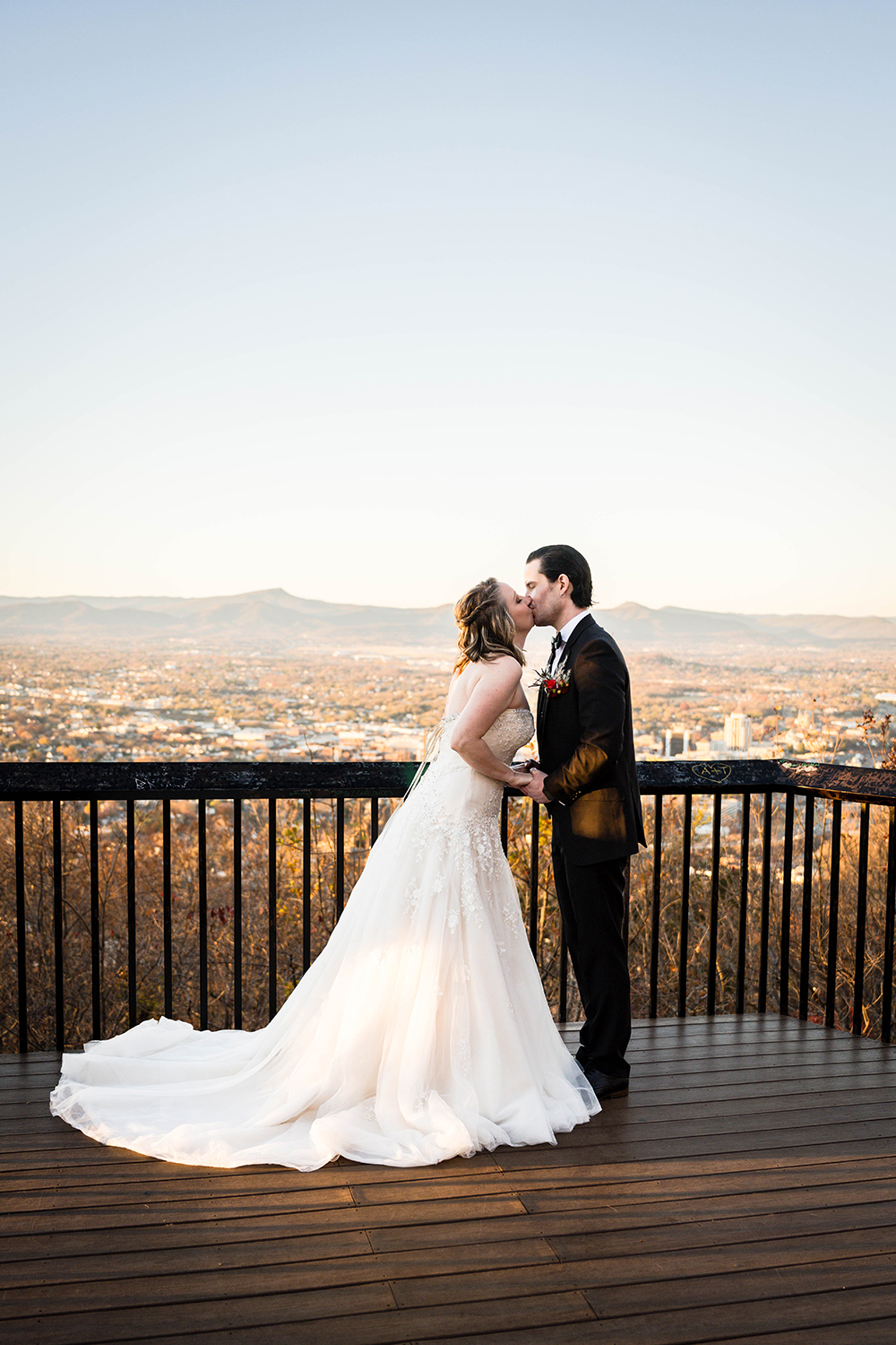 A couple on their elopement day go in for their first kiss during their ceremony in Roanoke, Virginia.