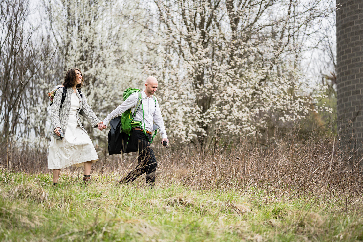 A couple holds hands as they hike along the Blue Ridge Parkway in Virginia on their elopement day.