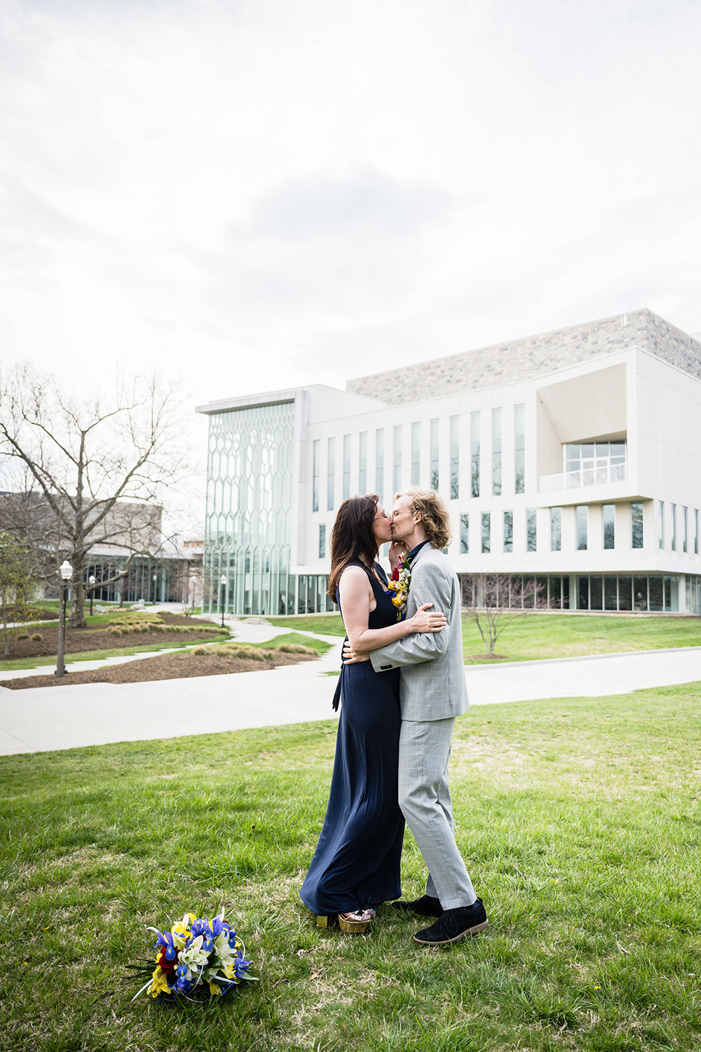 A couple go in for their first kiss following their intimate ceremony outside of the Virginia Tech Moss Arts Center in Blacksburg. 