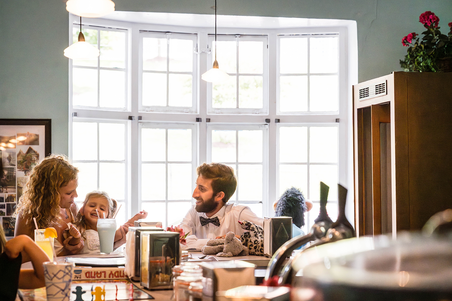 A family of three sit at the bar of Pop's Soda and Ice Cream Bar in Grandin Village in Roanoke, Virginia. The trio enjoys a milkshake together.