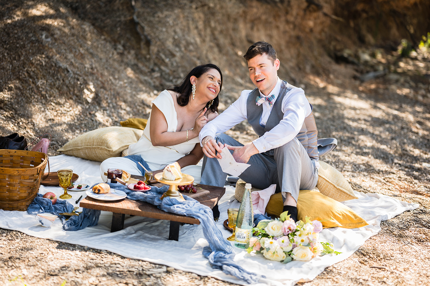 A couple enjoys a picnic together under the shade at Carvin's Cove during their elopement in Roanoke, VA.