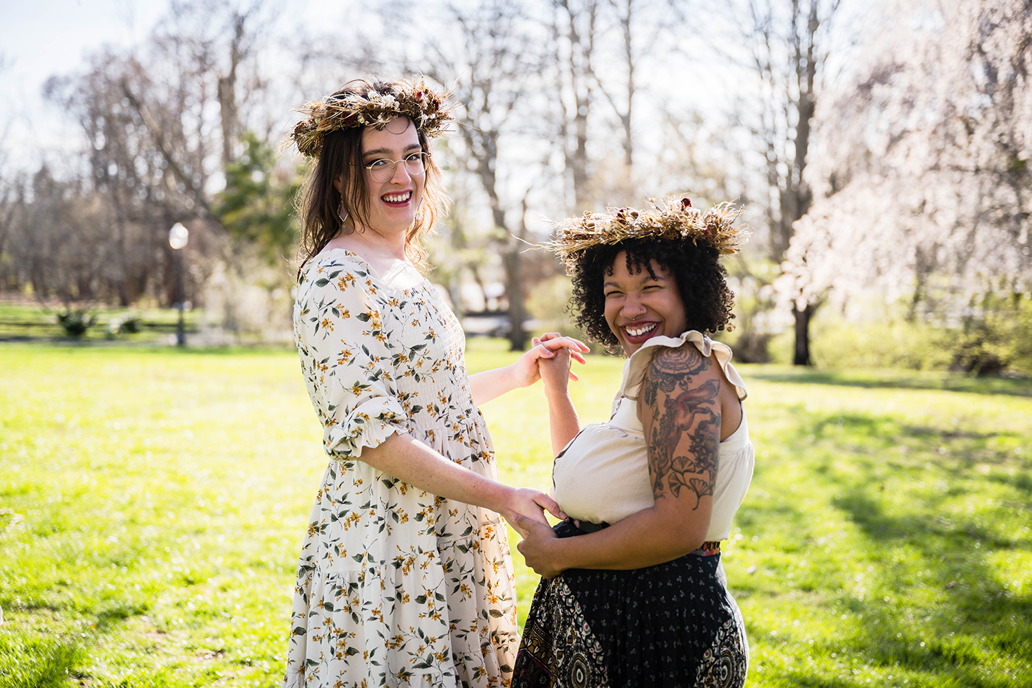 An LGBTQ+ couple smiles widely during their first dance after their elopement ceremony at Duck Pond on Virginia Tech's campus in Blacksburg.