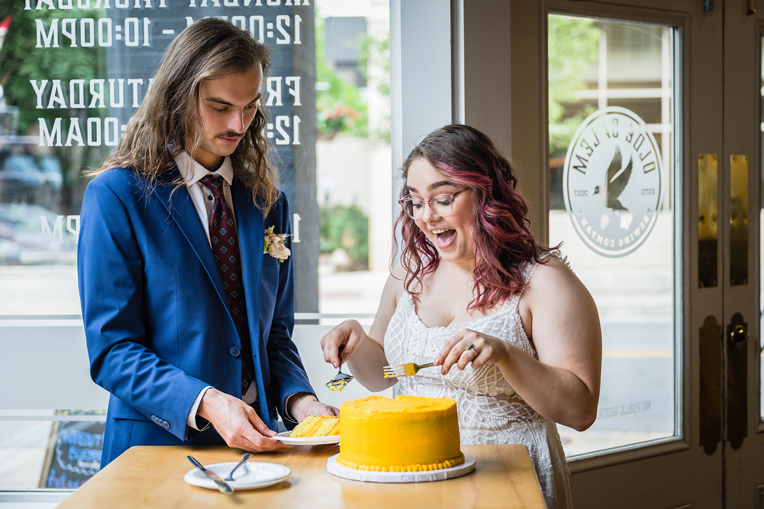 A couple cuts into their cake on their elopement day in Roanoke, Virginia at Olde Salem Brewing Company.