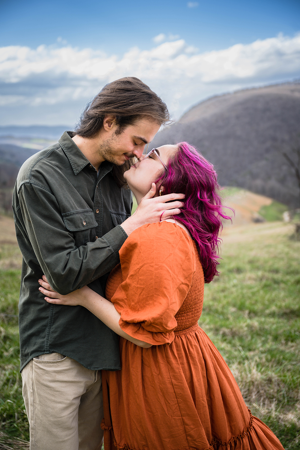 A couple holds onto one another before they kiss during their anniversary photoshoot in Giles County, Virginia.