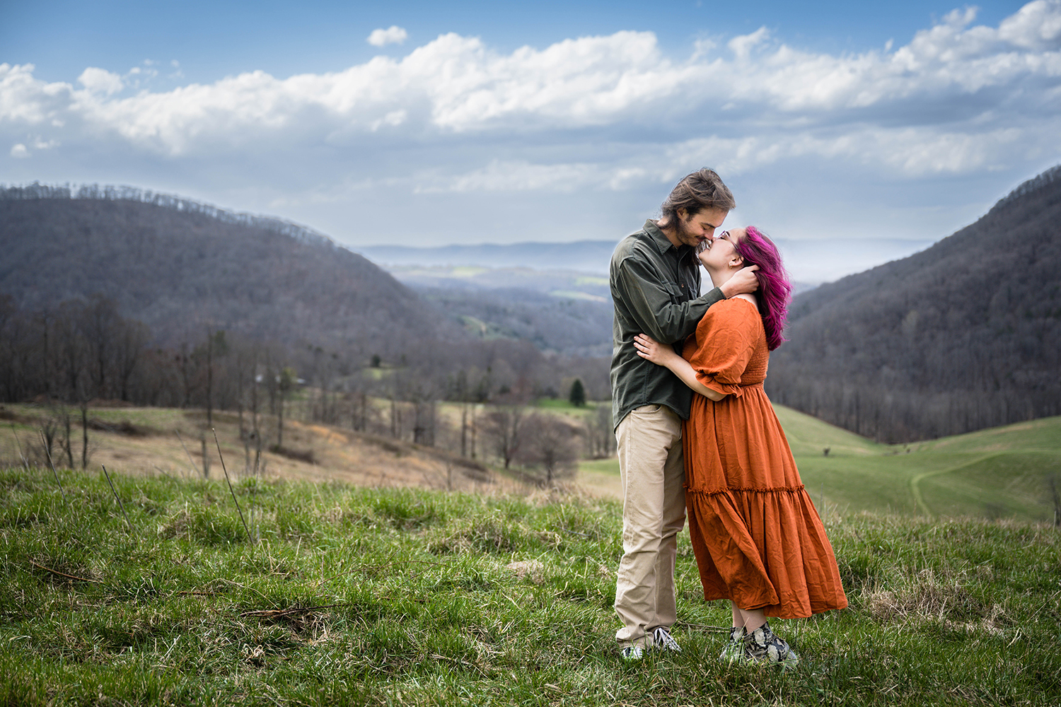 A couple holds onto one another before they kiss during their anniversary photoshoot in Giles County, Virginia.