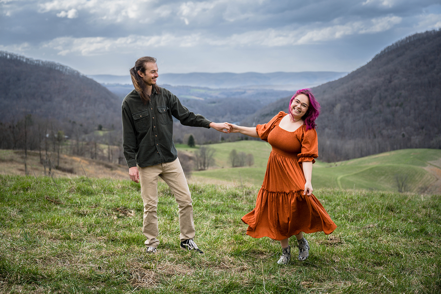 A man twirls his partner for a photo during their anniversary photo session in Giles County, Virginia.