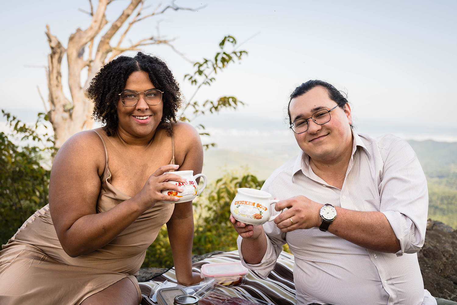 An elopement couple smiles for a photo as they each hold a fun coffee mug in their hands.