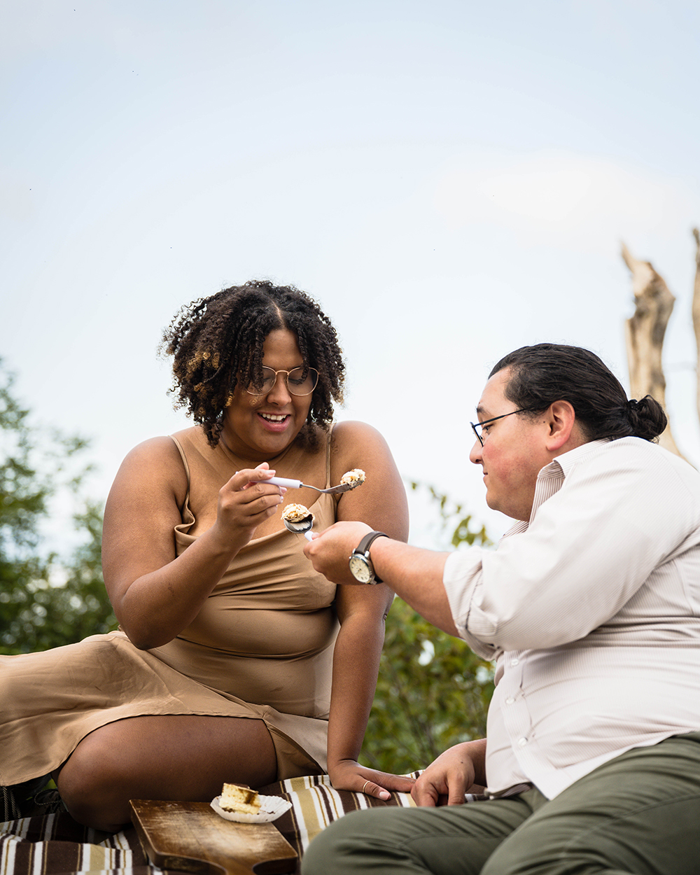 A wedding couple on their elopement day prepares to feed one another a bite of tiramisu. 