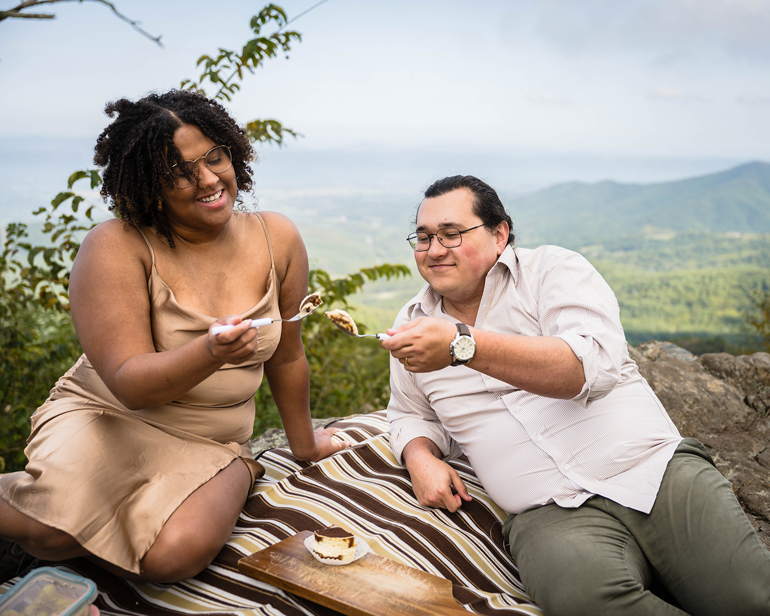 A couple on their elopement day prepares to feed one another a bite of tiramisu. 