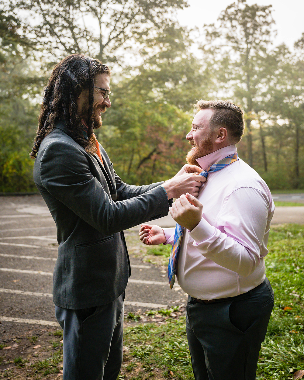 An LGBTQ+ marrier helps their partner tie their tie in the Blackrock Summit parking lot in Shenandoah National Park. 